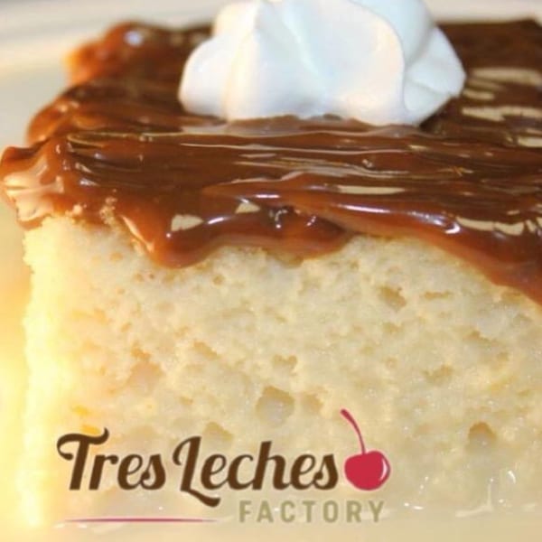 Slice of Tres Leches cake with caramel topping and whipped cream, branded "Tres Leches Factory".
